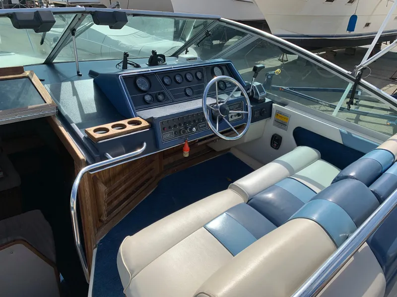 Slide: The Image of 1987 Sea Ray 268 Sundancer boat interior with steering wheel and control panel. - 9