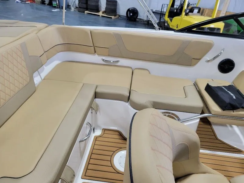 Slide: The Image of 2024 Bayliner VR5 boat interior with tan seating and wood accents. - 12