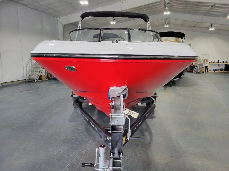 Slide: The Image of 2024 Bayliner VR5 boat with red hull on trailer in indoor showroom. - 4