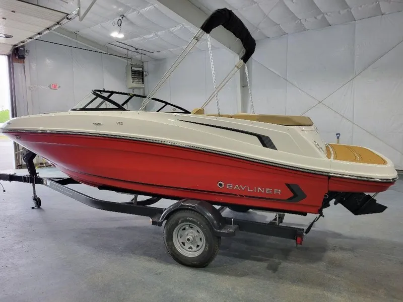 Slide: The Image of 2024 Bayliner VR5 boat with red hull on trailer in indoor storage. - 6