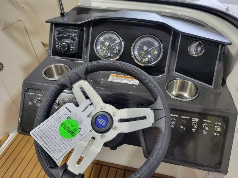 Slide: The Image of 2024 Bayliner VR5 boat dashboard with steering wheel, gauges, and control panel. - 7