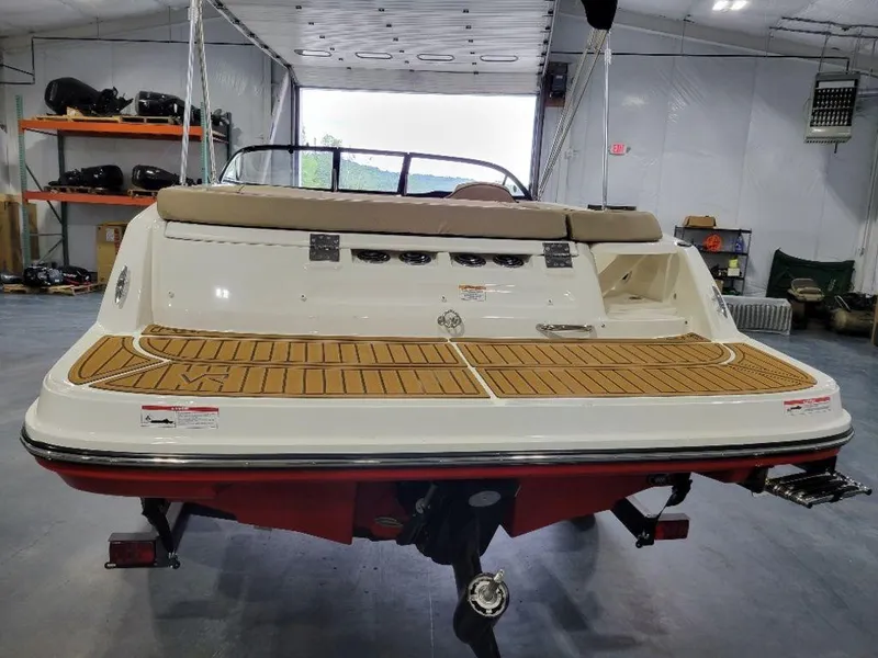 Slide: The Image of 2024 Bayliner VR5 boat in a garage, rear view showing swim platform. - 8