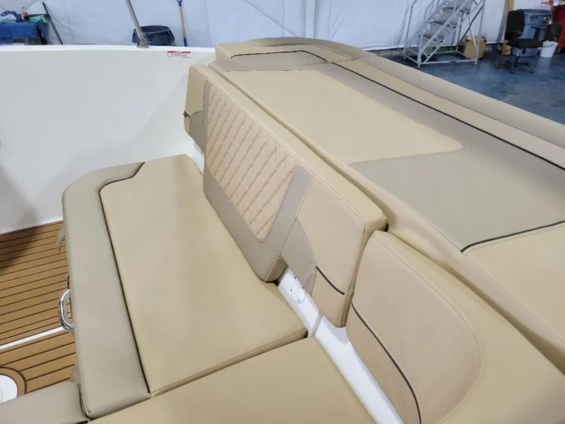 Slide: The Image of 2024 Bayliner VR5 boat interior with beige cushioned seating. - 9
