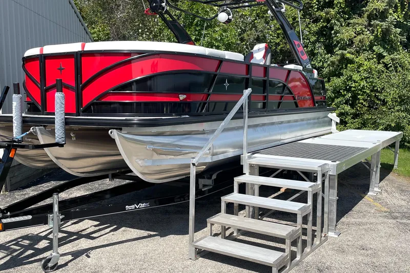 Slide: The Image of 2023 Berkshire 23 RFX STS pontoon boat on trailer with boarding steps. - 0