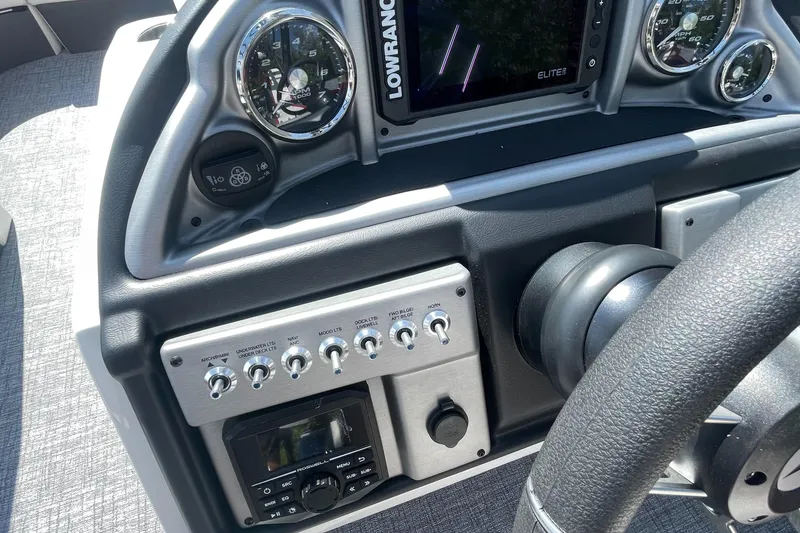 Slide: The Image of 2023 Berkshire 23 RFX STS boat dashboard with Lowrance Elite display and control panel. - 12