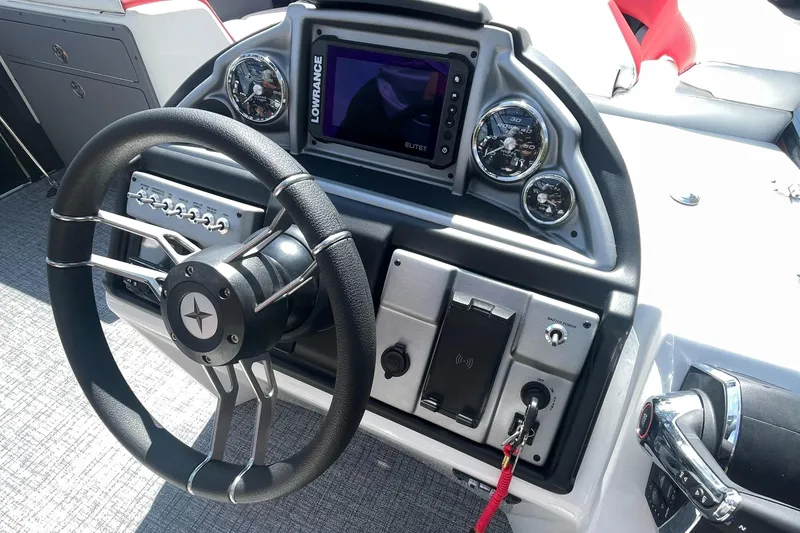 Slide: The Image of 2023 Berkshire 23 RFX STS boat dashboard with steering wheel and navigation system. - 13