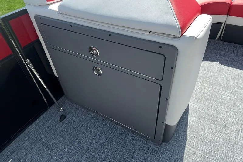 Slide: The Image of 2023 Berkshire 23 RFX STS boat interior storage compartment with gray and red seating. - 15