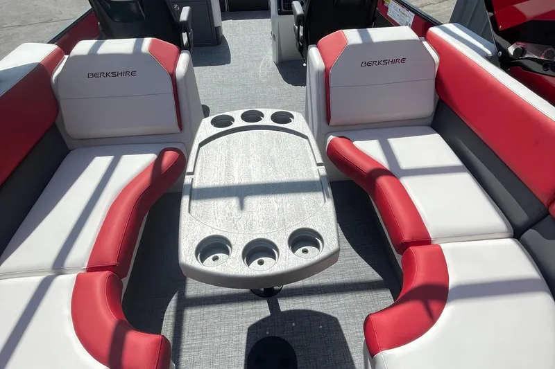 Slide: The Image of 2023 Berkshire 23 RFX STS boat interior with red and white seating and a central table. - 5