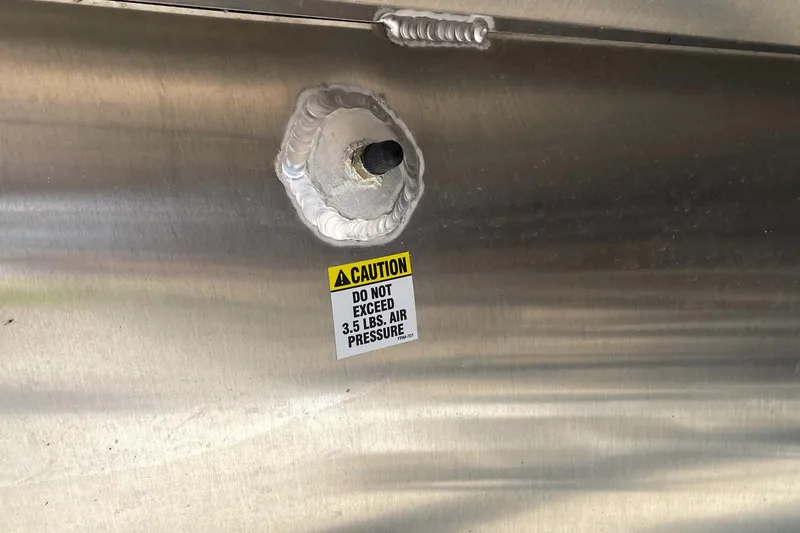 Slide: The Image of Caution label on 2023 Berkshire 23 RFX STS boat, air pressure warning. - 9