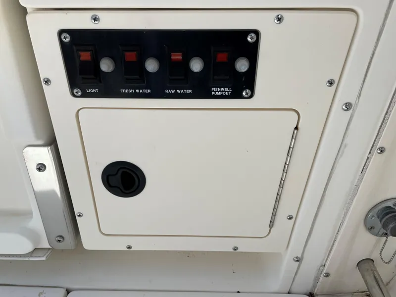 Slide: The Image of Control panel on a 1999 Boston Whaler Outrage 23 boat. - 14