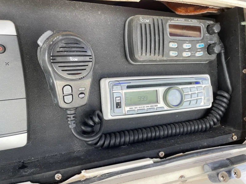 Slide: The Image of ICOM radio and control panel on a 1999 Boston Whaler Outrage 23 boat. - 16