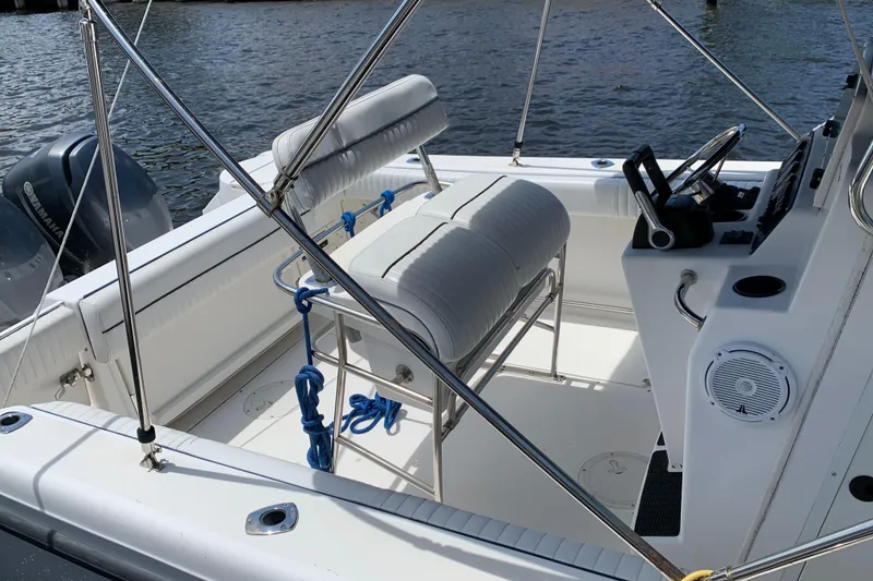 Slide: The Image of 1999 Boston Whaler Outrage 23 boat interior with seating and steering console. - 3