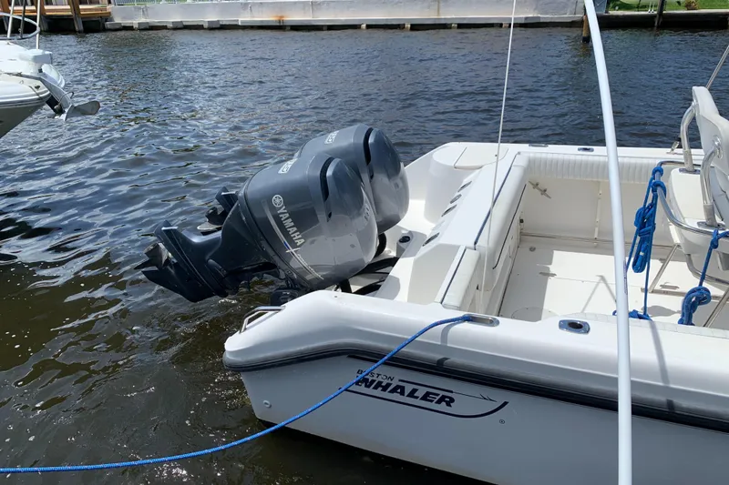 Slide: The Image of 1999 Boston Whaler Outrage 23 boat with Yamaha outboard engines docked. - 4