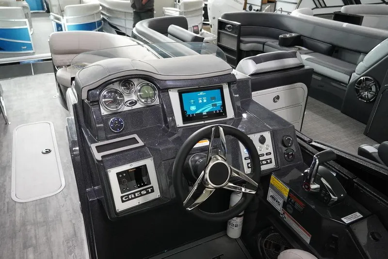 Slide: The Image of 2024 Crest Savannah 270 SLC CP3 boat dashboard with modern controls and touchscreen display. - 6