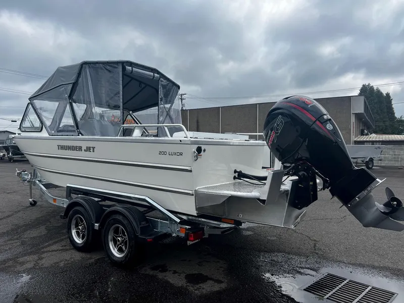 Slide: The Image of 2024 Thunder Jet 200 Luxor boat on a trailer with an outboard motor. - 4