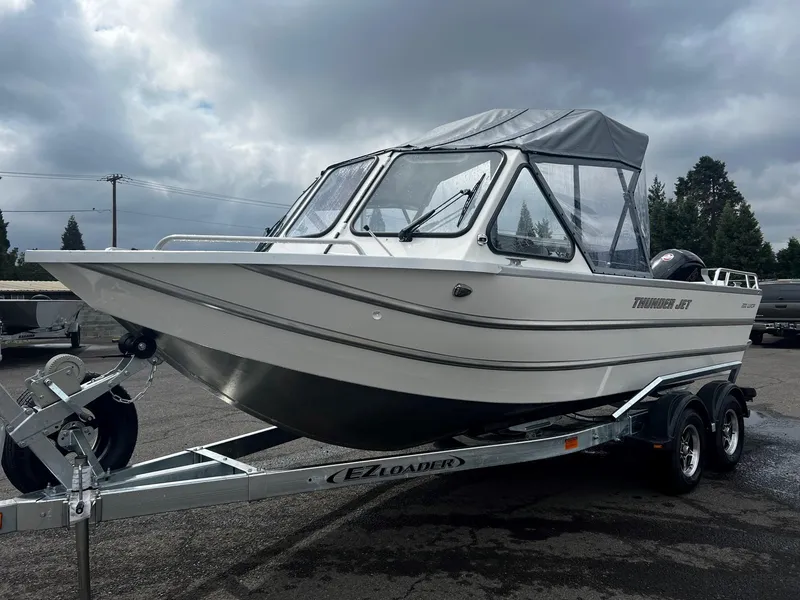 Slide: The Image of 2024 Thunder Jet 200 Luxor boat on trailer under cloudy sky. - 6