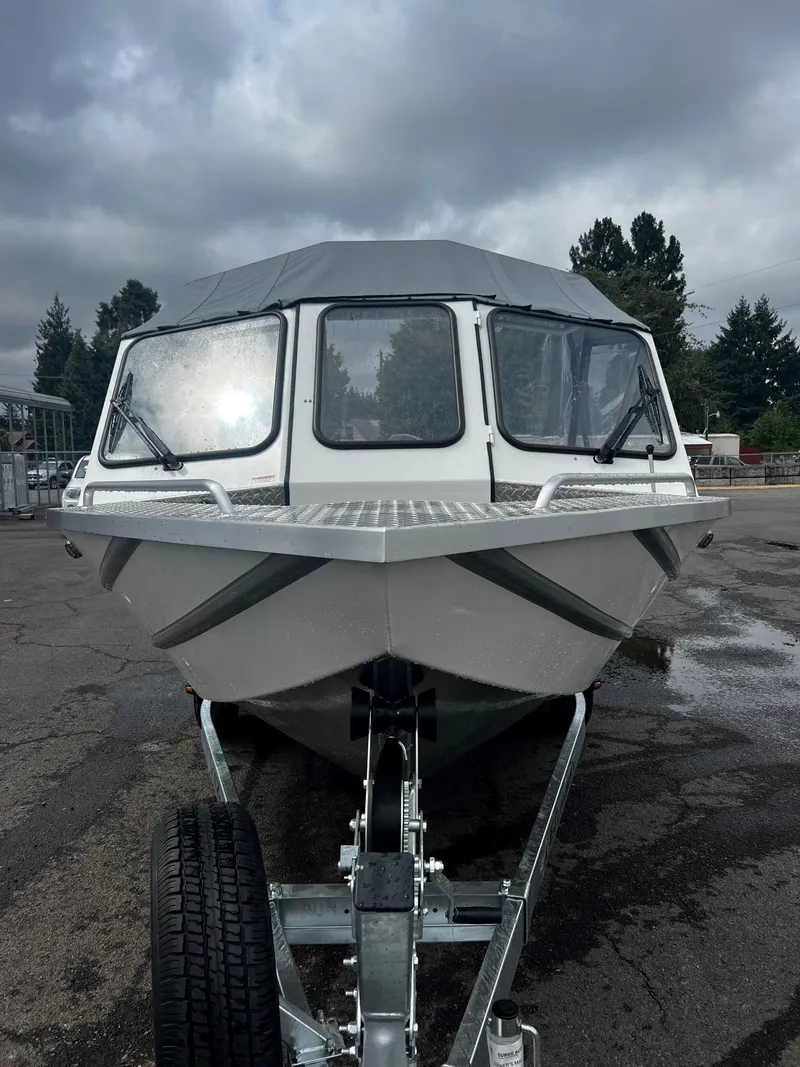 Slide: The Image of 2024 Thunder Jet 200 Luxor boat on trailer, front view under cloudy sky. - 7