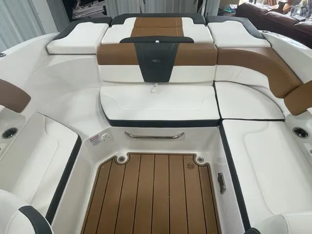 Slide: The Image of 2024 Chaparral 23 SSi boat interior with white and brown seating. - 4