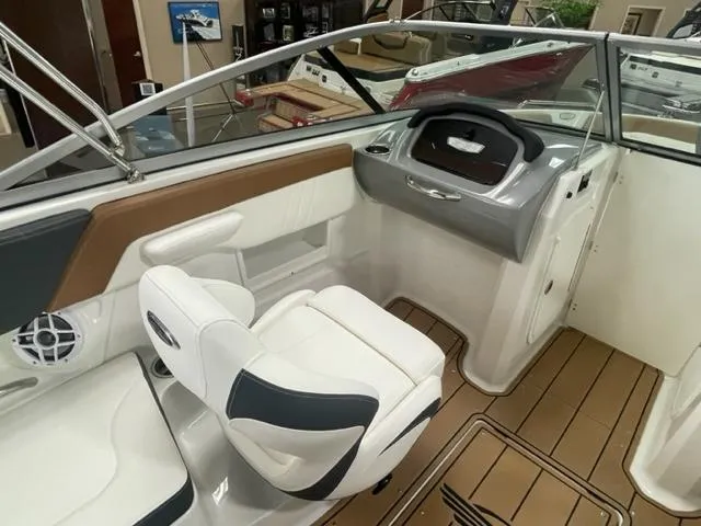 Slide: The Image of 2024 Chaparral 23 SSi boat interior with white and brown seating, modern dashboard. - 7