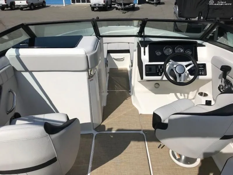 Slide: The Image of 2024 Sea Ray 230 SPX boat interior with modern dashboard and seating. - 10