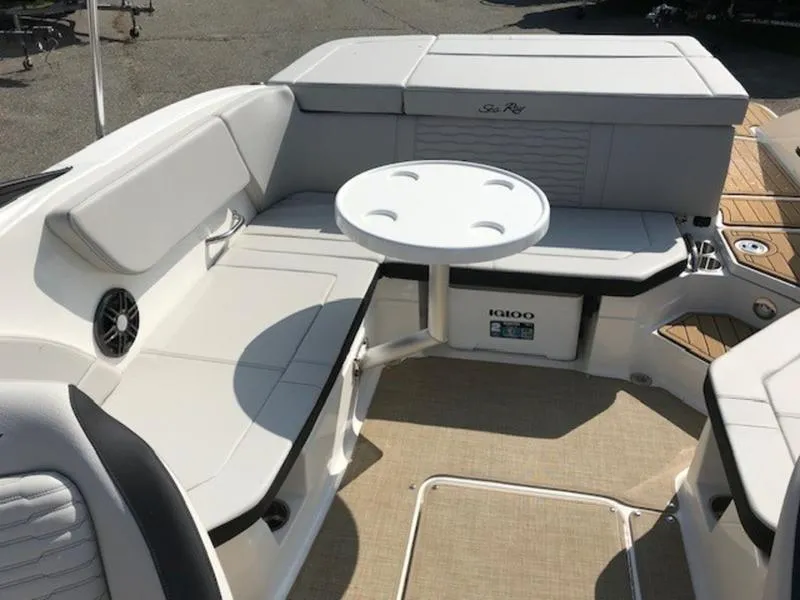 Slide: The Image of 2024 Sea Ray 230 SPX boat interior with seating and table. - 14