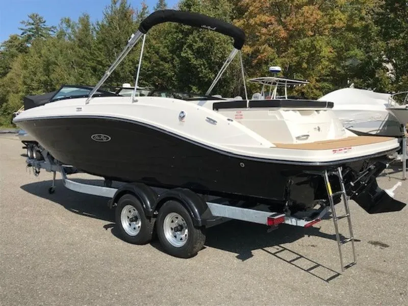 Slide: The Image of 2024 Sea Ray 230 SPX boat on trailer, black and white design, parked outdoors. - 5
