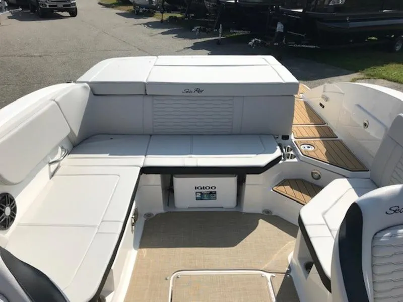 Slide: The Image of 2024 Sea Ray 230 SPX boat interior with white seating and storage area. - 8