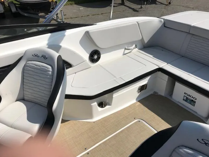 Slide: The Image of 2024 Sea Ray 230 SPX boat interior with white seating and modern design. - 9