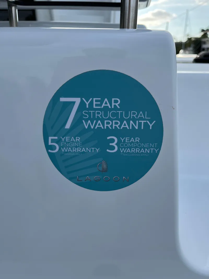 Slide: The Image of 2024 Lagoon 46 yacht with an inflatable dinghy docked in a serene marina. - 10