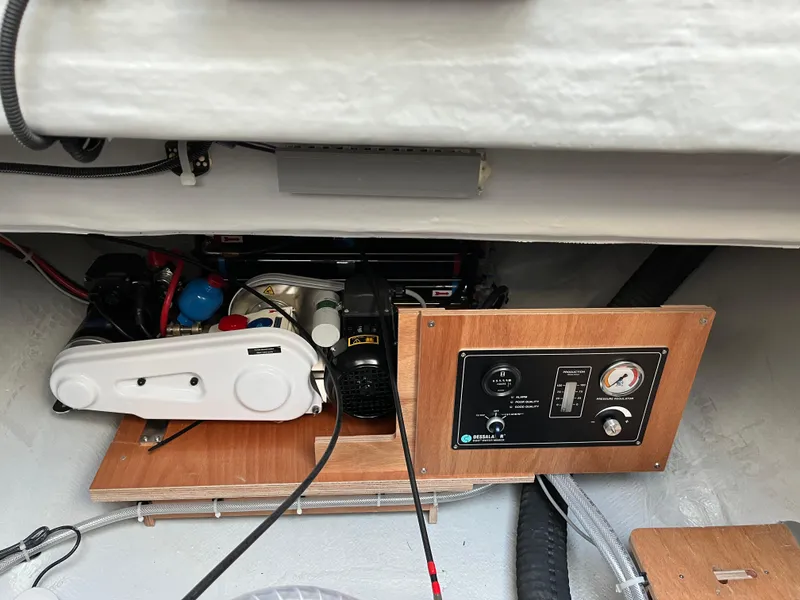 Slide: The Image of 2024 Lagoon 46 catamaran docked, showcasing sleek deck and sail. - 11