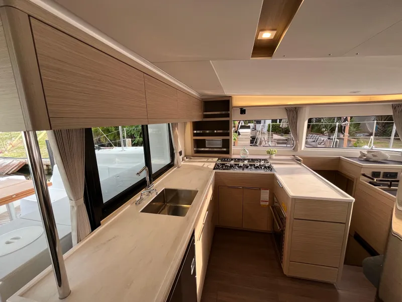 Slide: The Image of Engine compartment of a 2024 Lagoon 46 catamaran with batteries and wiring. - 14