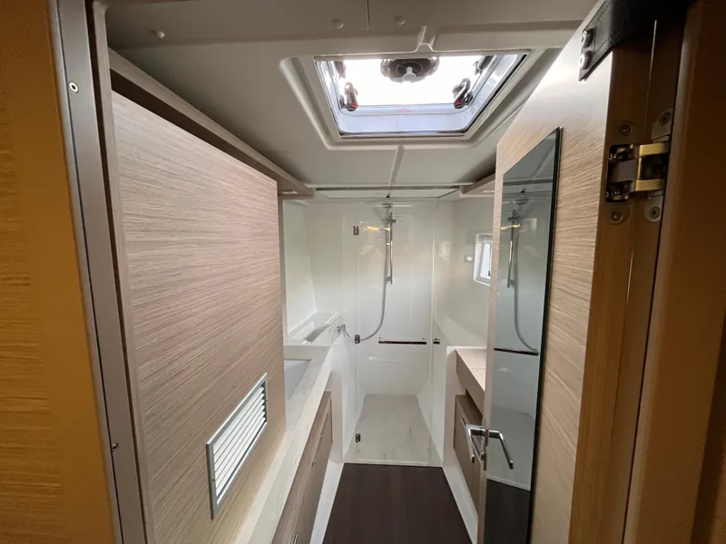 Slide: The Image of Modern bathroom in 2024 Lagoon 46 yacht with sleek sink, shower, and storage. - 16