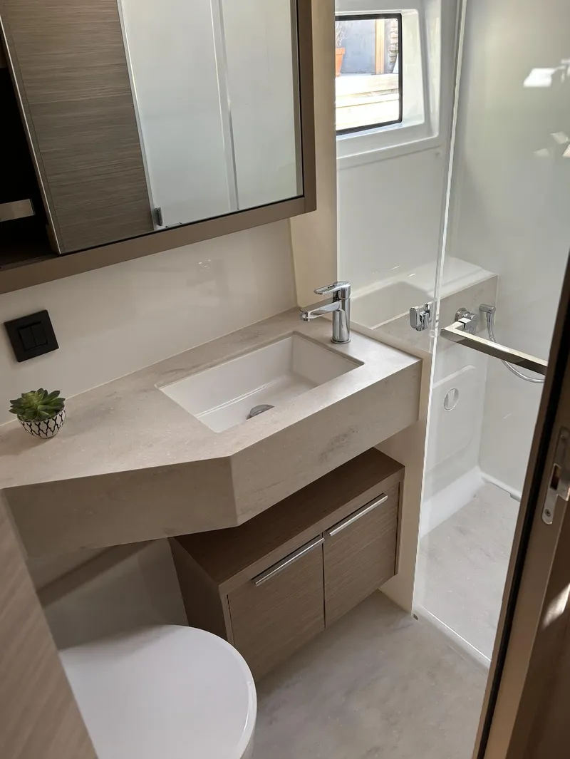 Slide: The Image of 2024 Lagoon 46 yacht bedroom with modern design and skylight. - 17