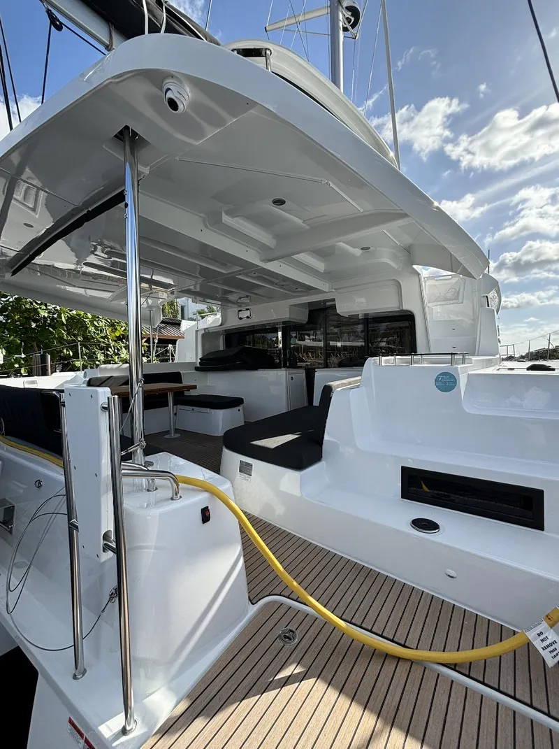 Slide: The Image of 2024 Lagoon 46 catamaran docked, showcasing sleek design and modern features. - 2