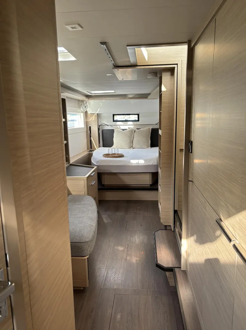 Slide: The Image of Modern bedroom interior of 2024 Lagoon 46 catamaran with skylight and cozy bed. - 23