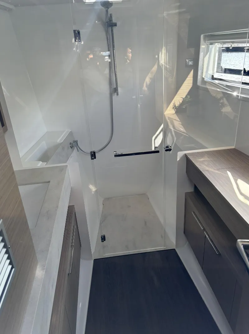 Slide: The Image of Modern interior of 2024 Lagoon 46 catamaran with navigation station and large window. - 24