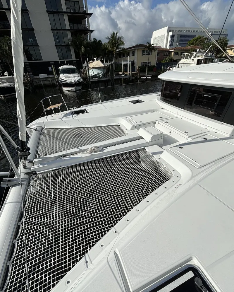 Slide: The Image of 2024 Lagoon 46 catamaran docked, featuring sleek design and modern amenities. - 3