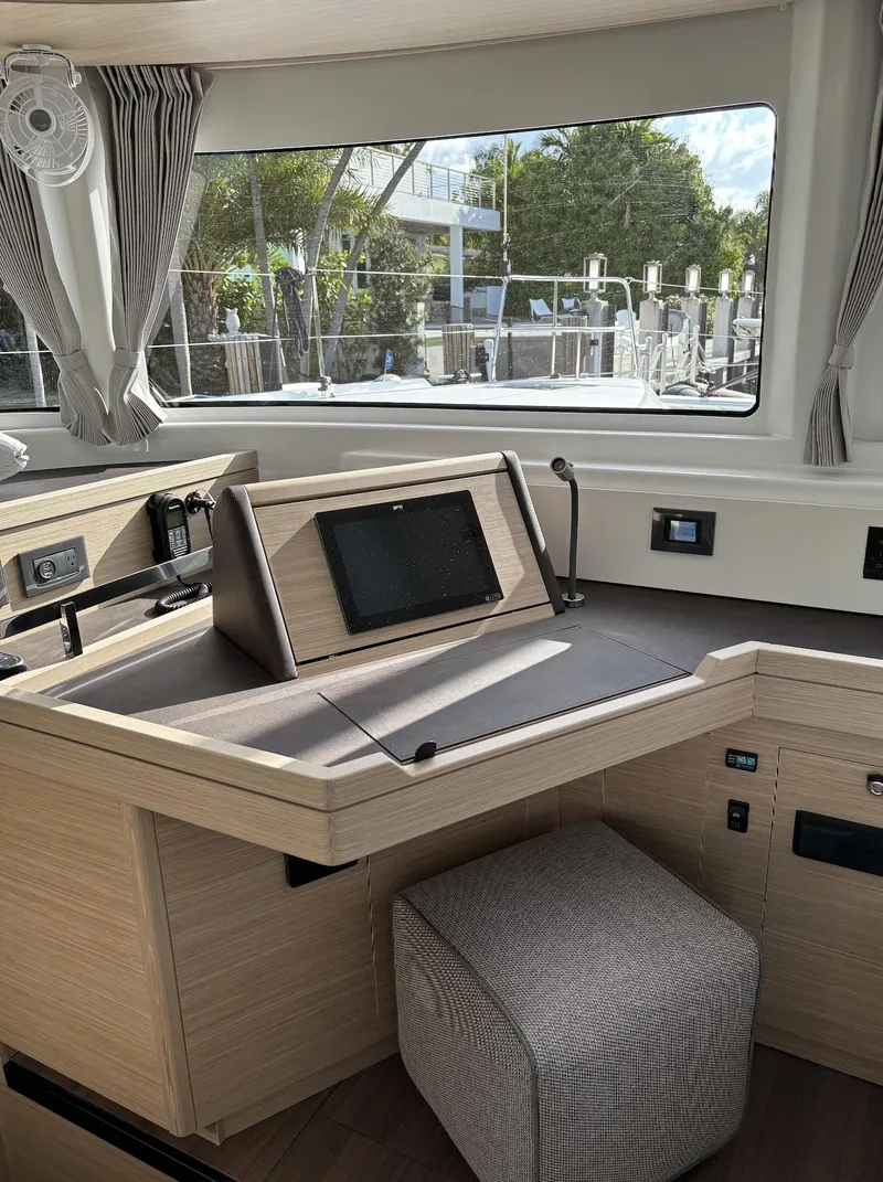 Slide: The Image of 2024 Lagoon 46 yacht with city skyline view at dusk. - 31