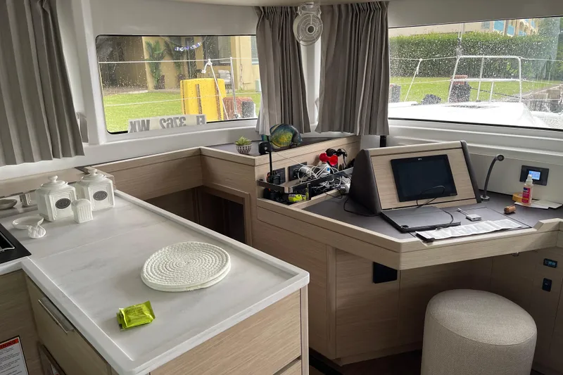 Slide: The Image of Interior of 2024 Lagoon 46 yacht with modern navigation station and kitchen area. - 42