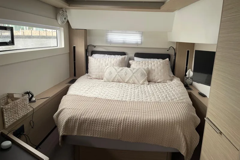 Slide: The Image of Luxurious bedroom interior of 2024 Lagoon 46 yacht with cozy bedding and modern design. - 45