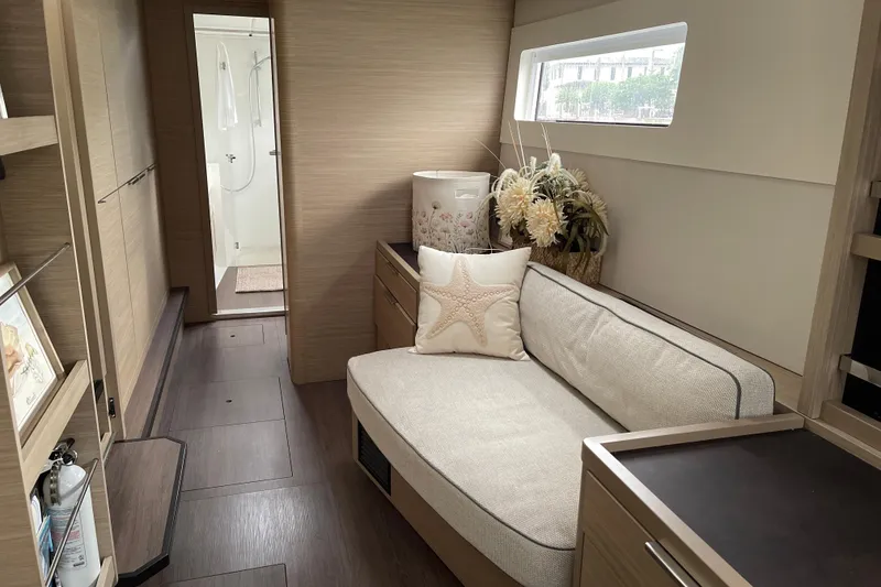 Slide: The Image of Luxurious interior of 2024 Lagoon 46 yacht with cozy seating and elegant decor. - 46