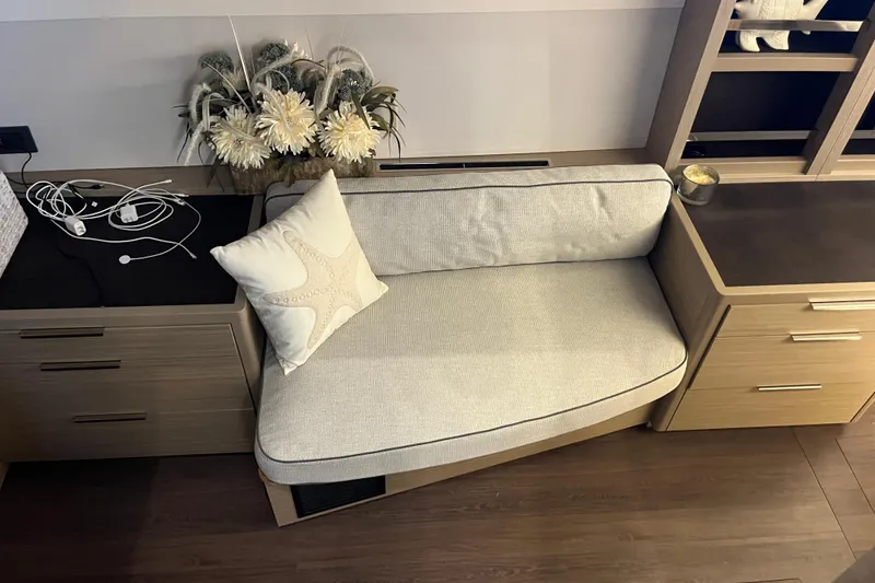 Slide: The Image of Cozy seating area on 2024 Lagoon 46 yacht with decorative pillow and floral arrangement. - 53