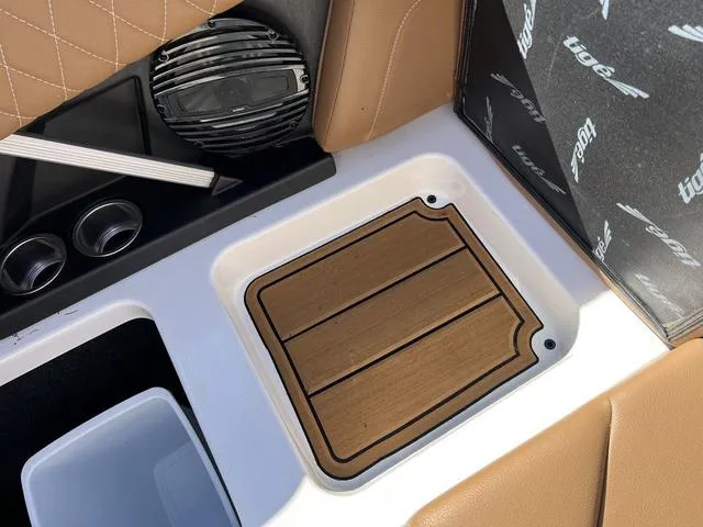 Slide: The Image of 2023 Tigé Z3 boat interior with teak flooring and tan leather seats. - 14