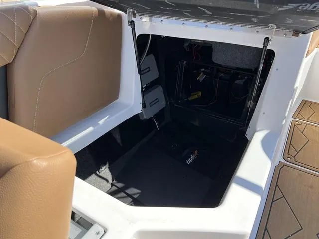 Slide: The Image of 2023 Tigé Z3 boat storage compartment with tan seating and open hatch. - 17
