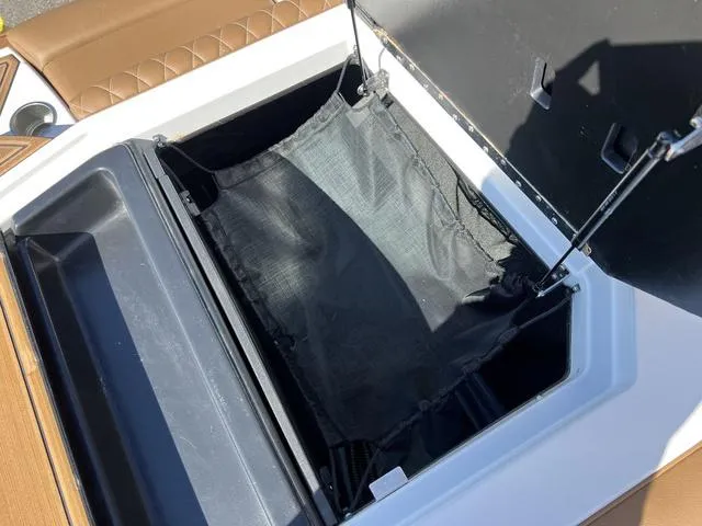 Slide: The Image of 2023 Tigé Z3 boat storage compartment with black mesh bag. - 18