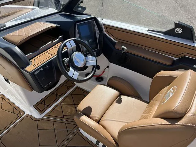 Slide: The Image of 2023 Tigé Z3 boat interior with modern dashboard and tan leather seats. - 4