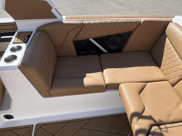 Slide: The Image of 2023 Tigé Z3 boat interior with tan leather seating and cup holders. - 6
