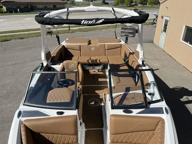 Slide: The Image of 2023 Tigé Z3 boat with luxurious brown interior and open bow design. - 9