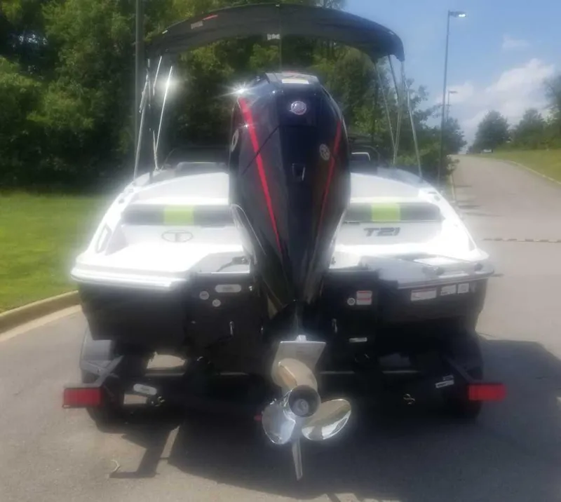 Slide: The Image of 2024 Tahoe T21 boat, aerial view on grass, showcasing seating and layout. - 3