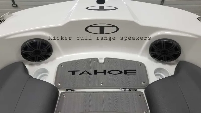 Slide: The Image of 2024 Tahoe T21 boat with canopy, parked on grass, featuring a powerful outboard motor. - 5